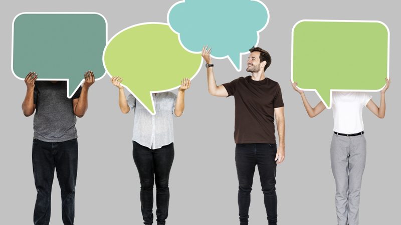 People holding colorful speech bubbles